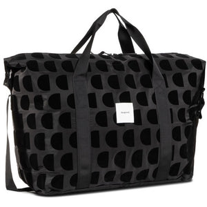 Black sports bag, long shoulder strap as well as handles. Half circle dark black colouring.